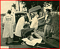 loading_patients_into_Packard_ambulance.jpg